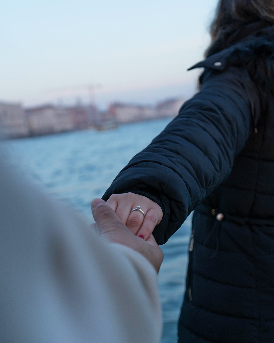 Manos tomadas con anillo de compromiso